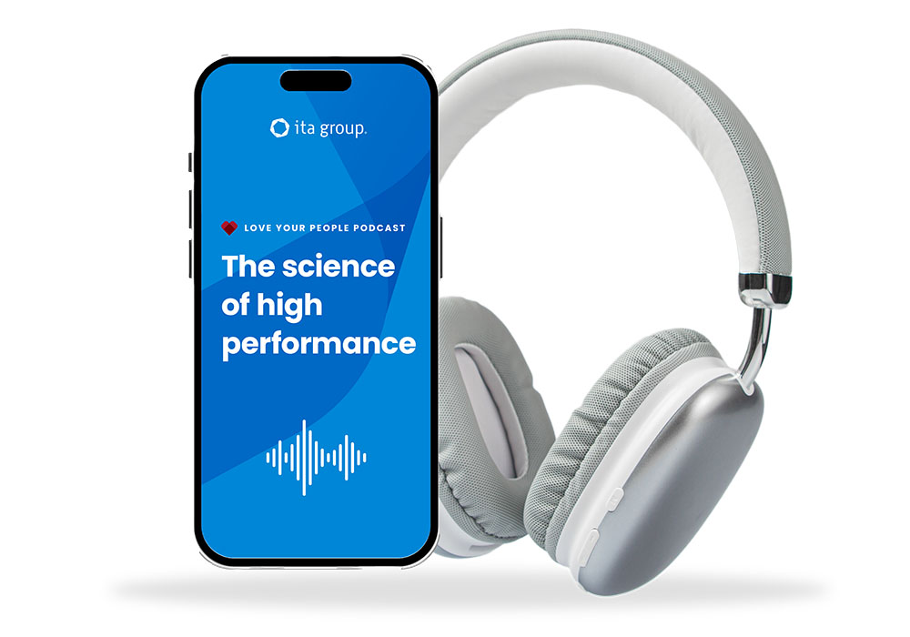 Image of mobile device playing ITA Group's podcast The science of high performance, next to a set of headphones